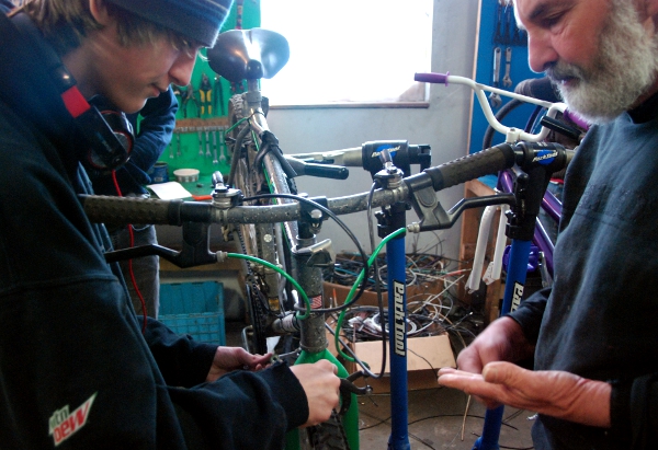 Francisco working with Gary on his bike.